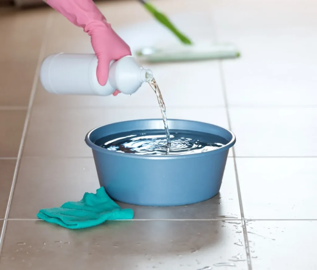 Cleaning skunk smell from house pouring bleach into bucket